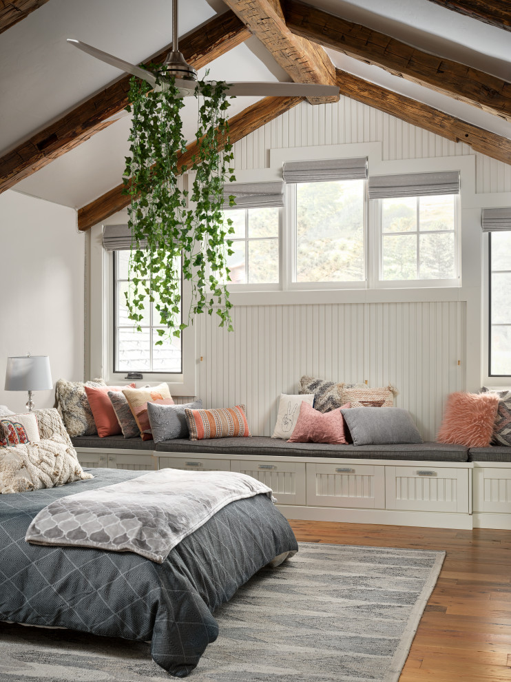 This is an example of a large rustic guest bedroom in Denver with grey walls, medium hardwood flooring, no fireplace, multi-coloured floors, a vaulted ceiling and wainscoting.