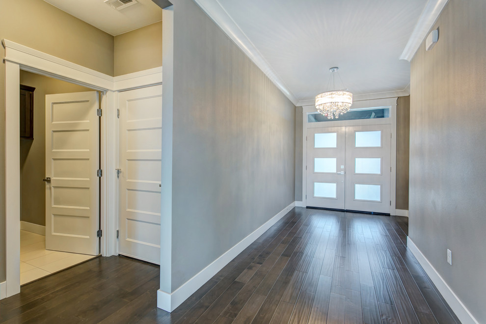 Inspiration for a mid-sized transitional medium tone wood floor entry hall remodel in Seattle with gray walls and a white front door