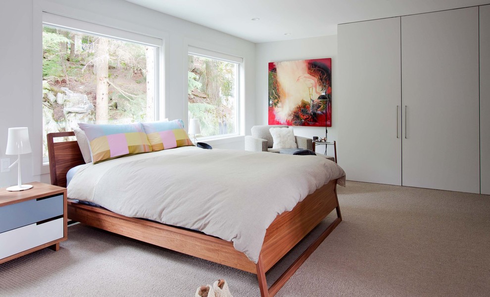 Large modern master bedroom in Vancouver with white walls, carpet and no fireplace.