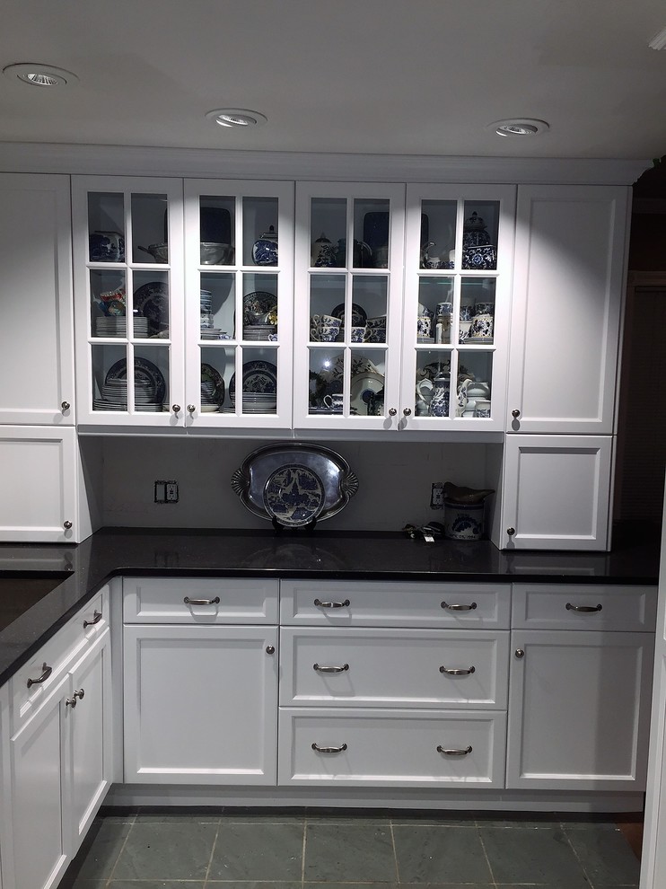 Inspiration for a mid-sized transitional galley eat-in kitchen in Philadelphia with granite benchtops, slate floors, an undermount sink, shaker cabinets, white cabinets, stainless steel appliances, a peninsula and grey floor.