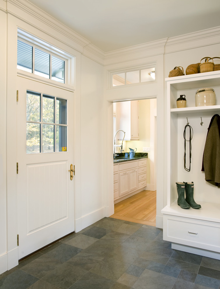 This is an example of a traditional mudroom in Boston with slate floors.