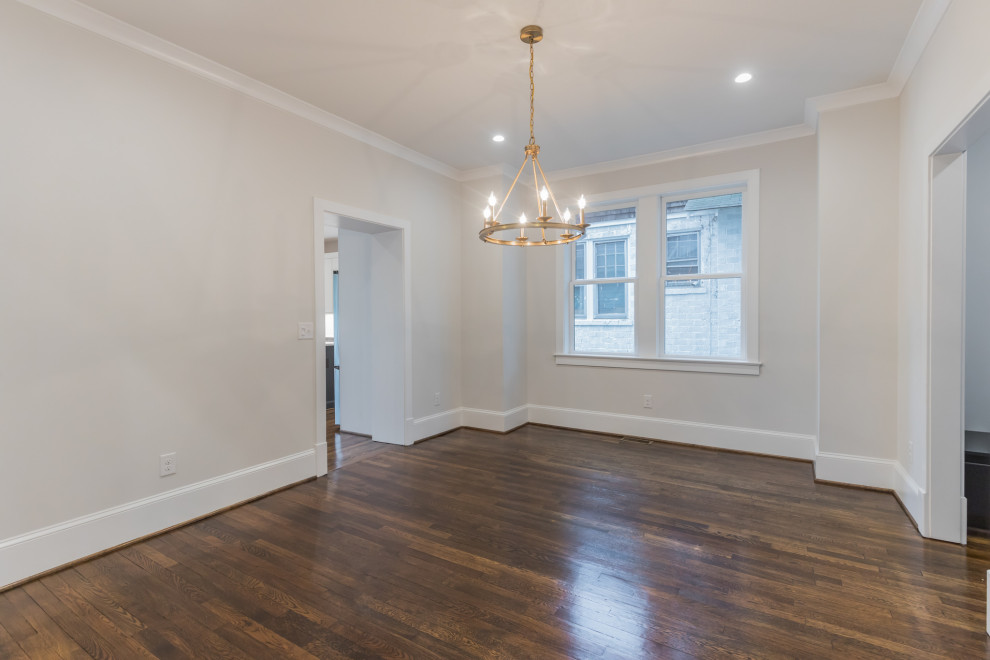 This is an example of a large transitional dining room in DC Metro with grey walls and dark hardwood floors.