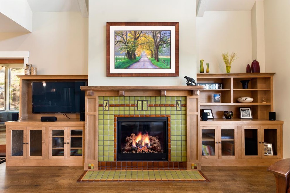 Arts and crafts living room in Other with white walls, medium hardwood floors, a standard fireplace, a wood fireplace surround and brown floor.