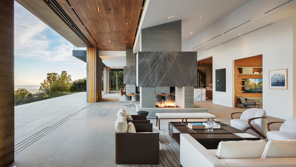 Inspiration for a modern formal open concept living room in Los Angeles with white walls, concrete floors, a two-sided fireplace, a concrete fireplace surround, no tv and grey floor.