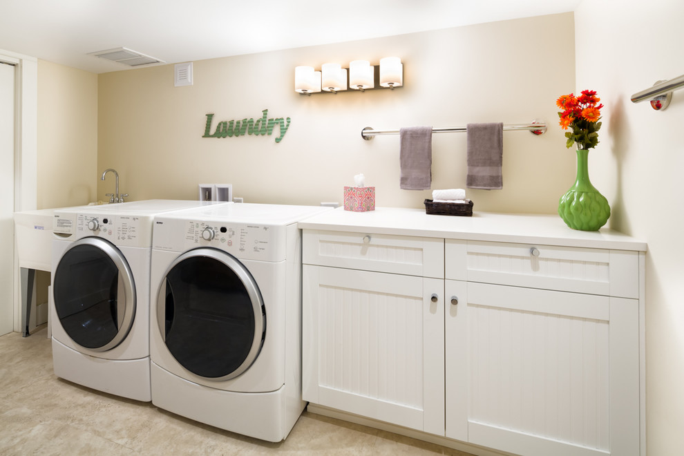 Design ideas for a mid-sized contemporary single-wall dedicated laundry room in Denver with an utility sink, flat-panel cabinets, white cabinets, beige walls, vinyl floors and a side-by-side washer and dryer.