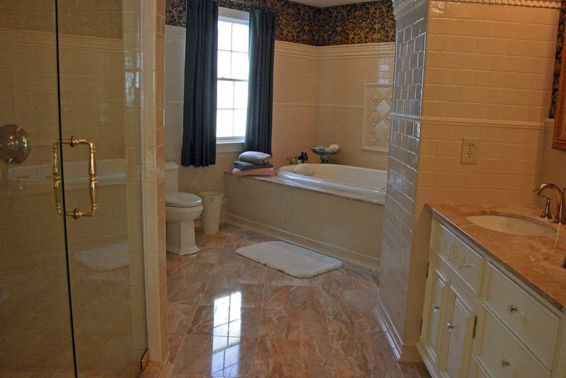 Inspiration for a large beige tile and ceramic tile ceramic tile corner shower remodel in Providence with white walls