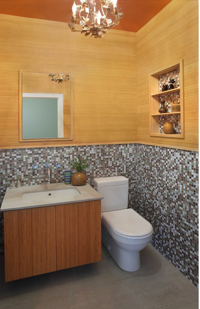 Photo of a contemporary powder room in New York with mosaic tile.