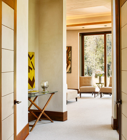 Inspiration for a mid-sized modern hallway in Denver with beige walls and carpet.