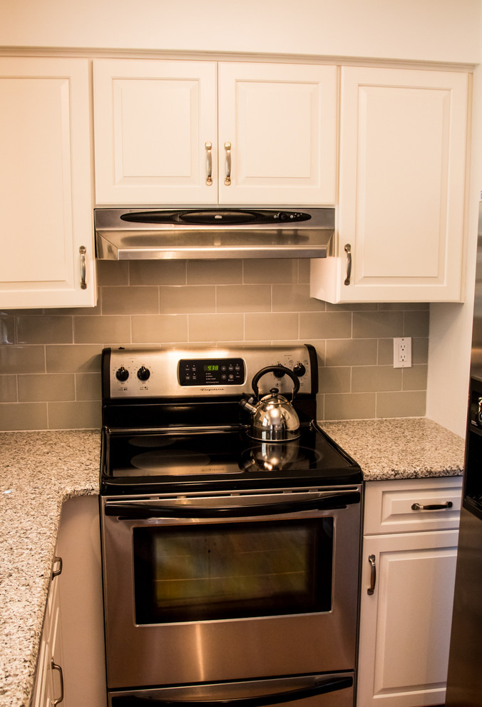 Kitchen - small transitional u-shaped light wood floor kitchen idea in Baltimore with an undermount sink, raised-panel cabinets, white cabinets and no island