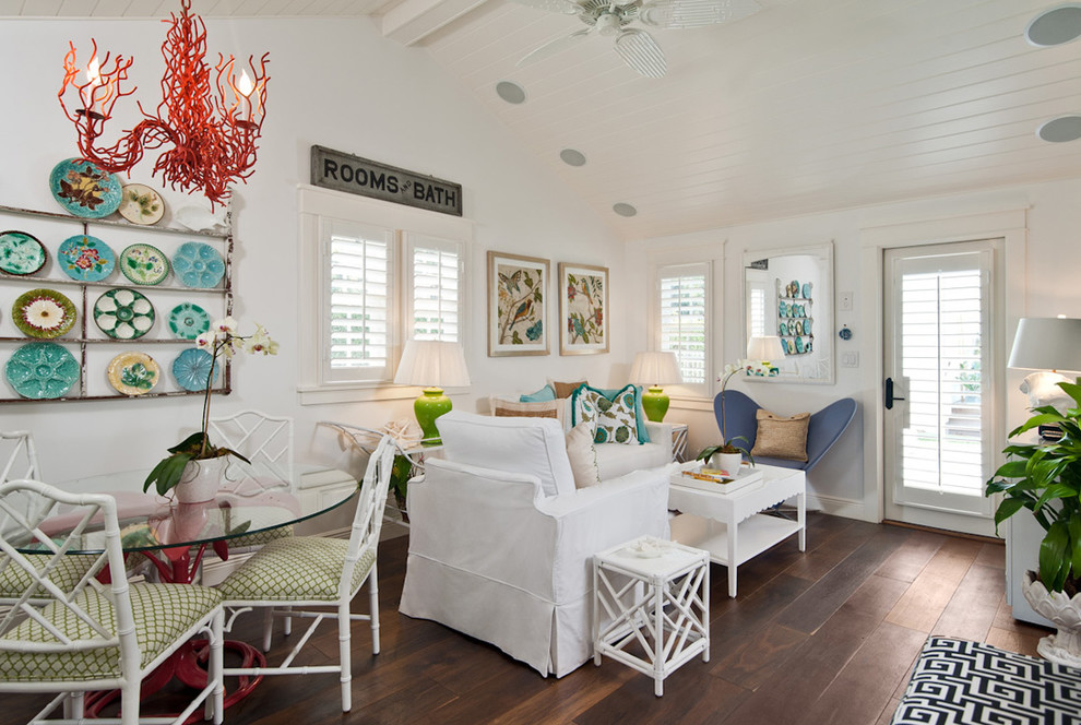 Design ideas for a tropical living room in Miami with white walls and dark hardwood floors.