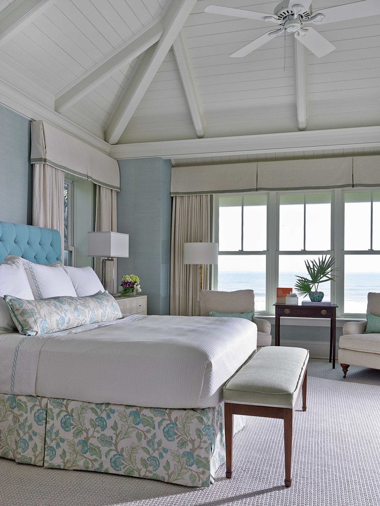 This is an example of a beach style master bedroom in Jacksonville with blue walls.
