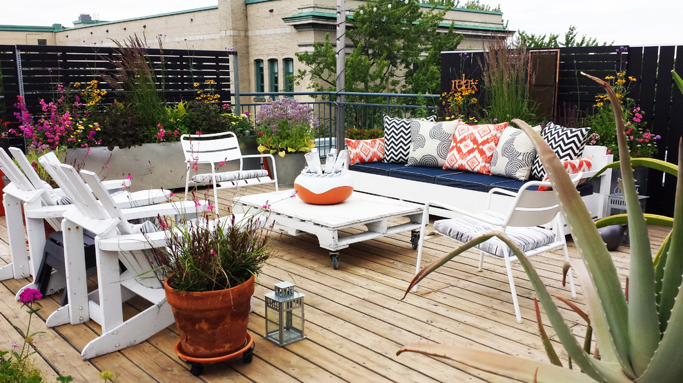 Design ideas for a small contemporary rooftop deck in Montreal with a container garden and no cover.