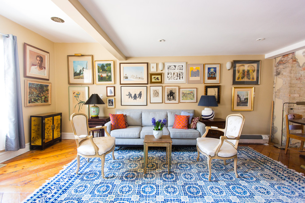 Traditional living room in Toronto with beige walls, medium hardwood floors and brown floor.