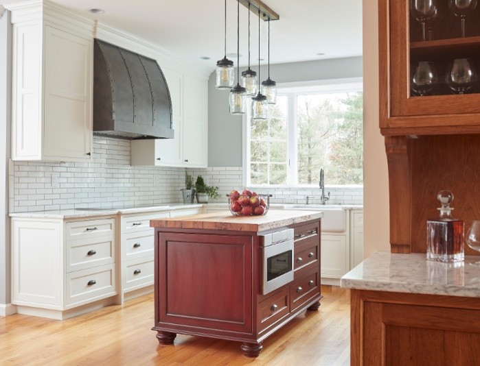 Large transitional u-shaped light wood floor eat-in kitchen photo in Boston with recessed-panel cabinets and an island