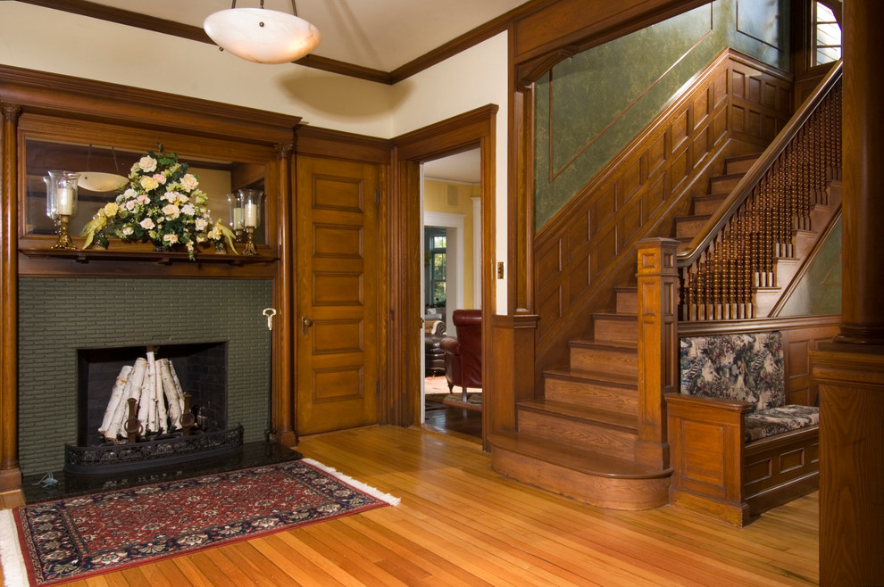This is an example of an expansive traditional foyer in Boston with medium hardwood floors and white walls.