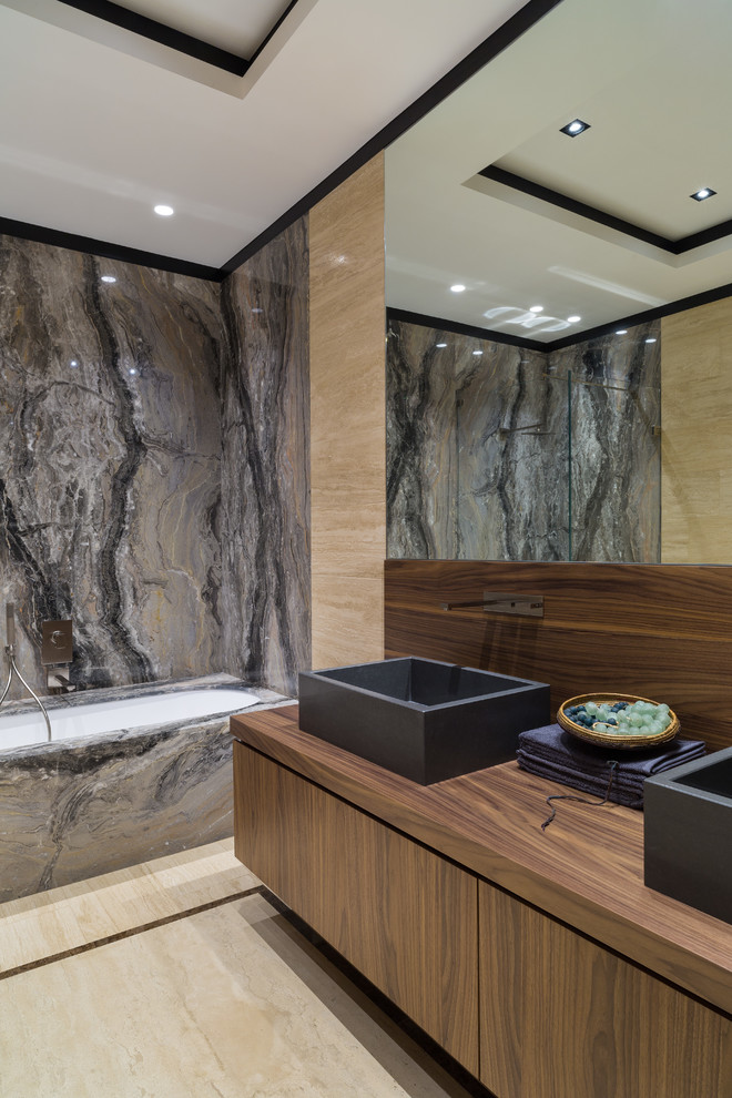 Inspiration for a large contemporary master bathroom in Moscow with flat-panel cabinets, an undermount tub, stone slab, travertine floors, wood benchtops, a vessel sink, dark wood cabinets, a shower/bathtub combo, black tile, gray tile and beige walls.