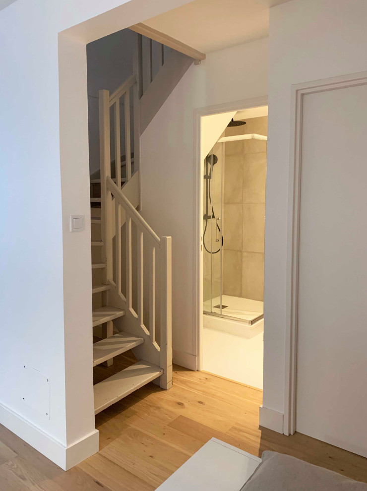 Example of a small classic 3/4 beige tile white floor and single-sink corner shower design in Montpellier with a wall-mount toilet, white walls, a drop-in sink, laminate countertops and white countertops