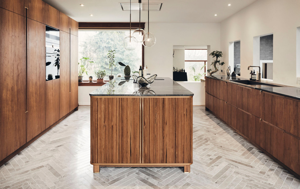 Design ideas for a small transitional open plan kitchen in Copenhagen with beaded inset cabinets, medium wood cabinets, marble benchtops, black appliances, marble floors, with island, grey floor and brown benchtop.