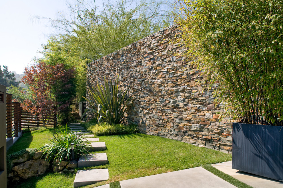 Design ideas for a contemporary backyard garden in Los Angeles with concrete pavers.
