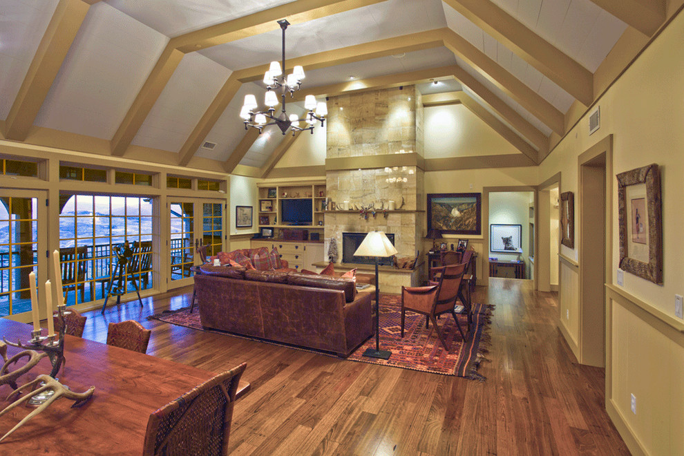 Photo of a large arts and crafts formal open concept living room in Salt Lake City with yellow walls, dark hardwood floors, a standard fireplace, a stone fireplace surround and no tv.