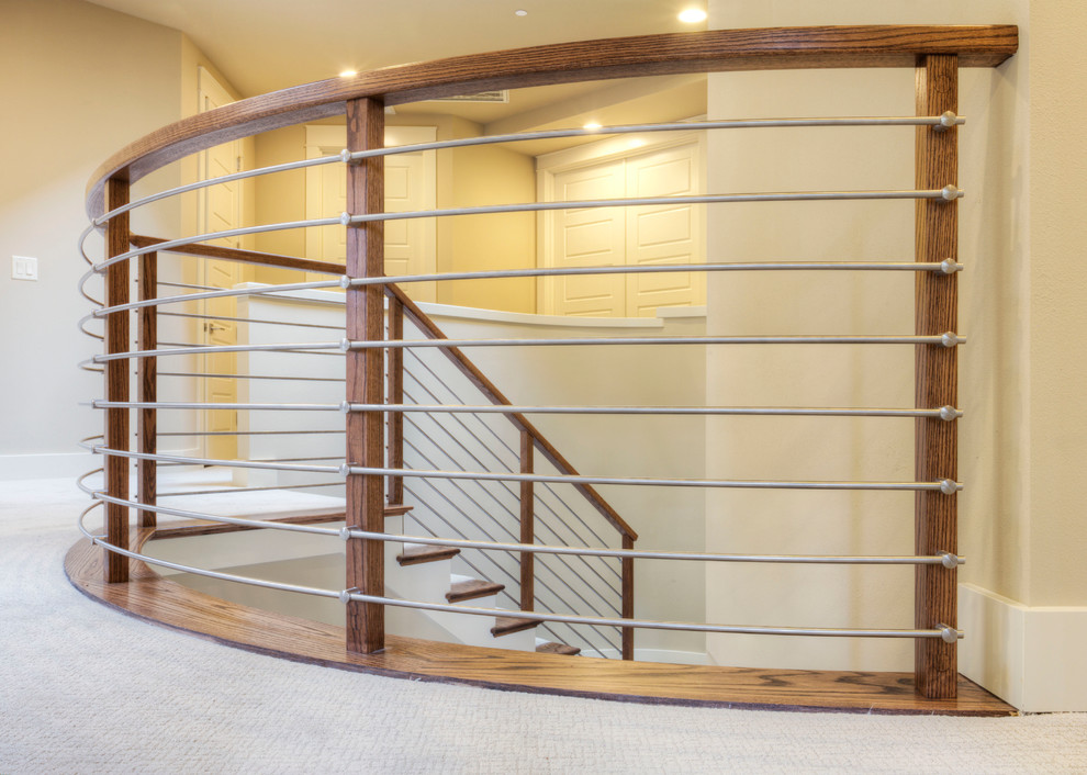 This is an example of a mid-sized modern carpeted curved staircase in Seattle with carpet risers.