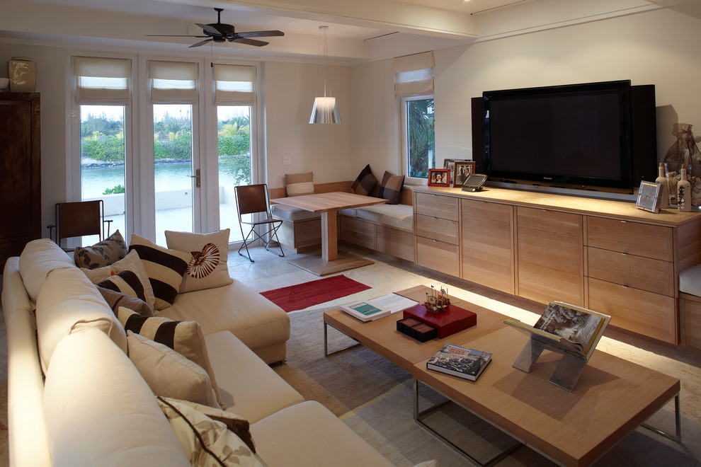 Mid-sized beach style formal enclosed living room in Other with beige walls, no fireplace and a freestanding tv.