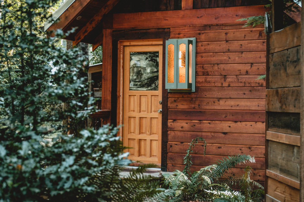 Inspiration for a small and multi-coloured rustic bungalow tiny house in Seattle with wood cladding, a pitched roof, a metal roof, a grey roof and shiplap cladding.