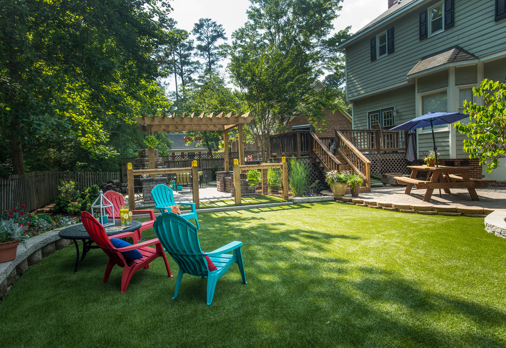 This is an example of a mid-sized traditional partial sun backyard brick landscaping in Raleigh.