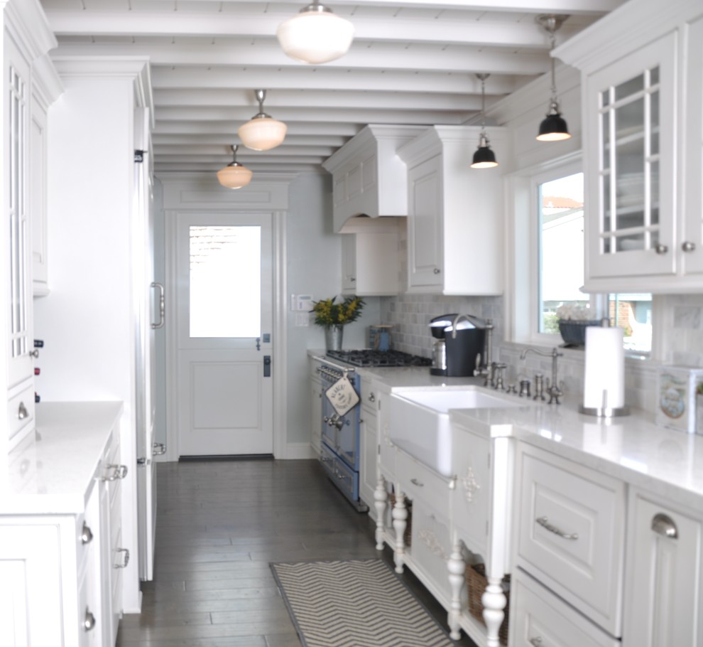 Mid-sized traditional galley kitchen pantry in Los Angeles with coloured appliances, a farmhouse sink, raised-panel cabinets, white cabinets, quartzite benchtops, grey splashback, marble splashback, medium hardwood floors, no island and grey floor.