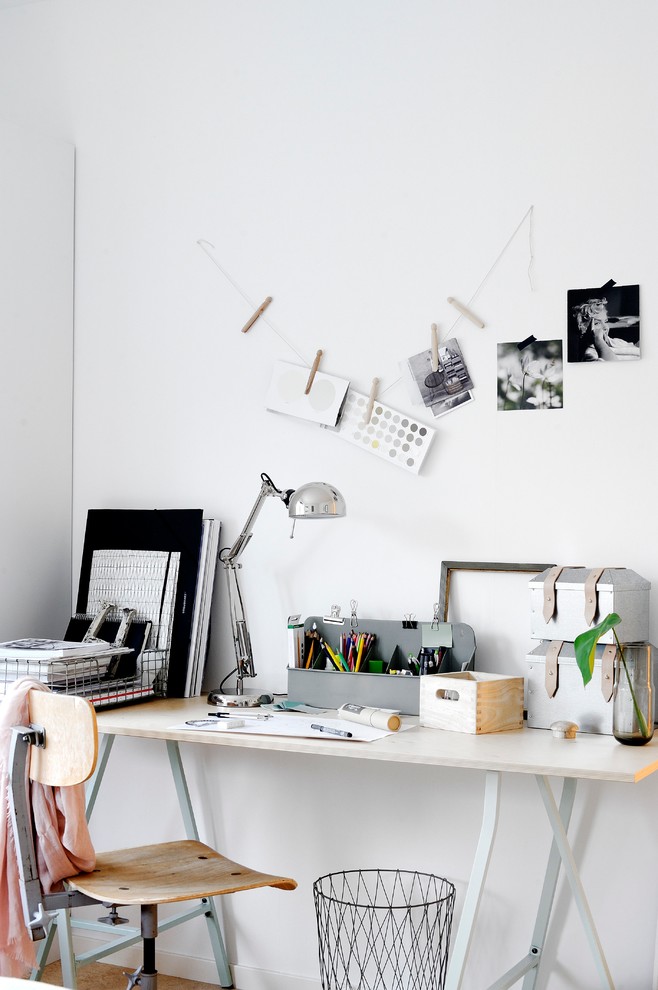 Photo of a scandinavian craft room in Orebro with white walls, a freestanding desk and no fireplace.