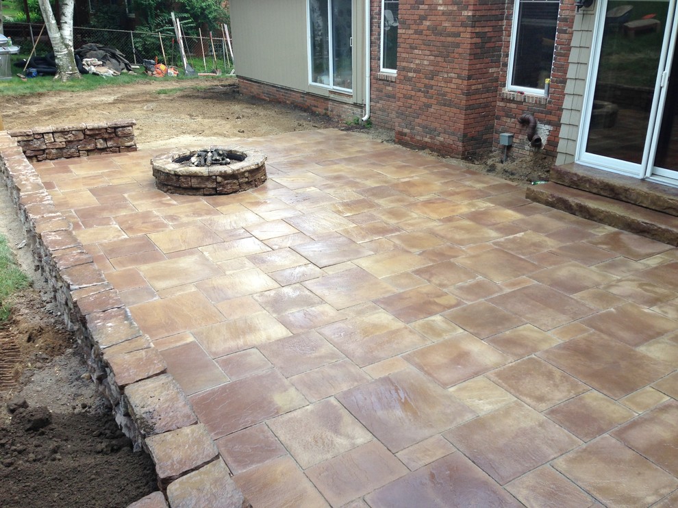 Inspiration for a large traditional backyard patio in Detroit with a fire feature, concrete pavers and no cover.