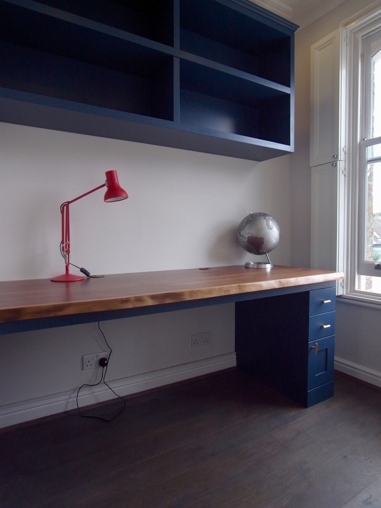 Photo of a small eclectic study room in London with grey walls, dark hardwood floors and a built-in desk.