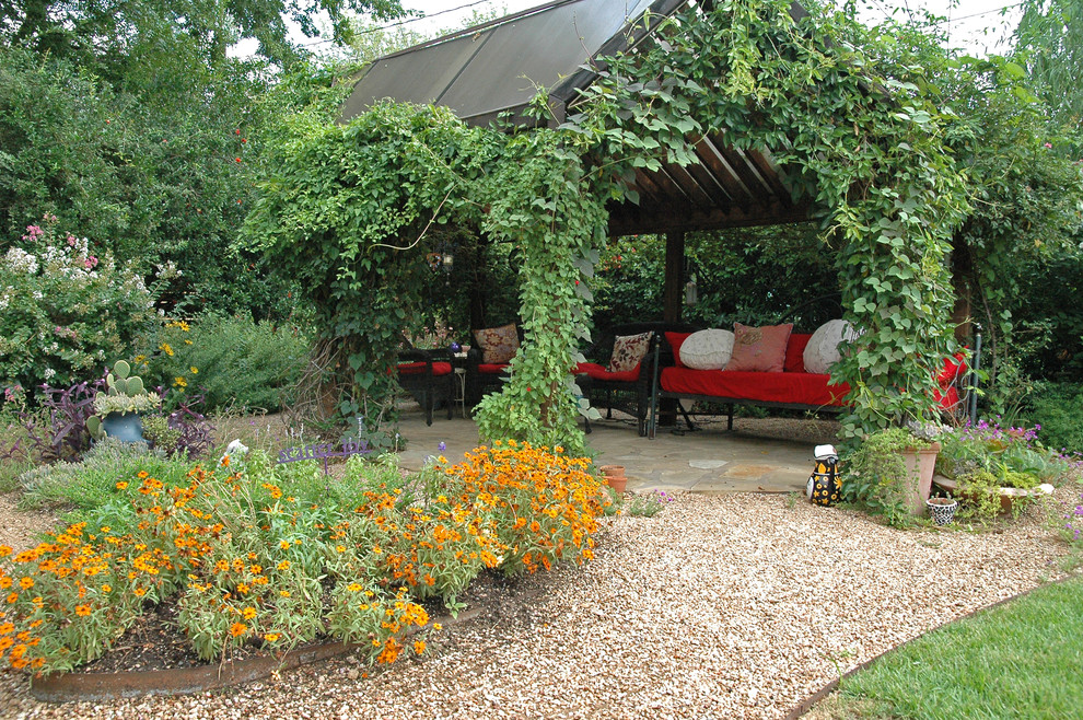 Large country backyard patio in Austin with a vertical garden, gravel and a gazebo/cabana.