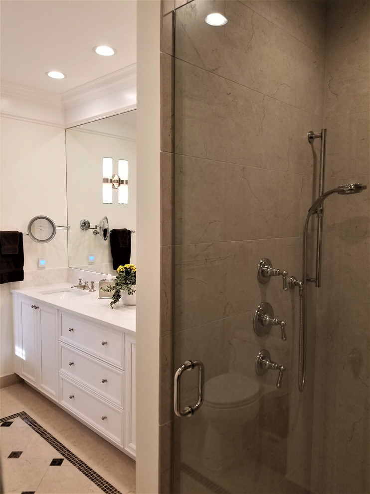 Design ideas for a mid-sized transitional master bathroom in New York with recessed-panel cabinets, white cabinets, a freestanding tub, an alcove shower, a one-piece toilet, yellow tile, yellow walls, porcelain floors, an undermount sink, engineered quartz benchtops, beige floor, a hinged shower door and beige benchtops.
