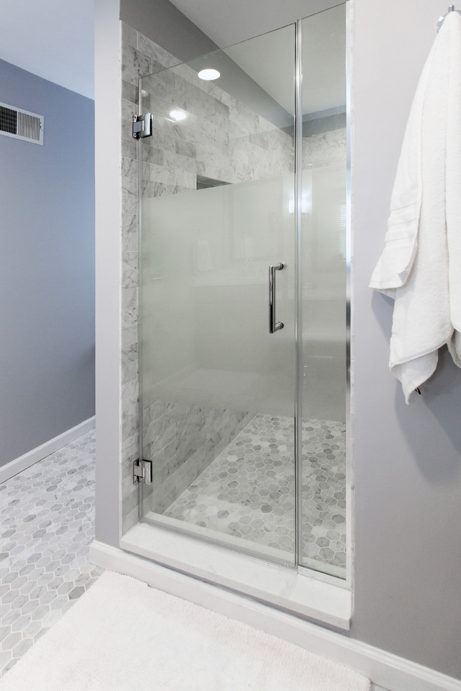 Inspiration for a mid-sized modern master bathroom in Philadelphia with an alcove shower, ceramic floors, grey floor, a hinged shower door, recessed-panel cabinets, grey cabinets, gray tile, ceramic tile, blue walls, an undermount sink, white benchtops and marble benchtops.