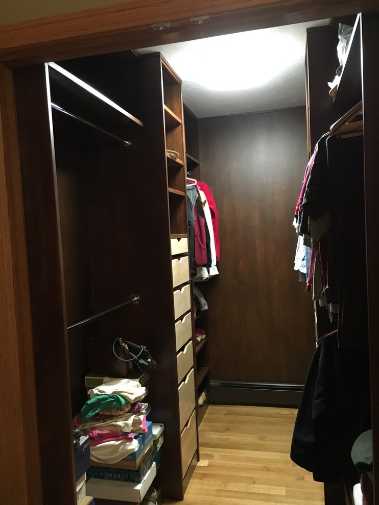Example of a mid-sized transitional light wood floor walk-in closet design with open cabinets and dark wood cabinets