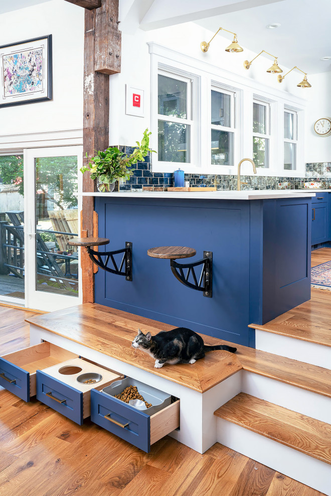 Photo of an eclectic kitchen in Boston with blue cabinets.