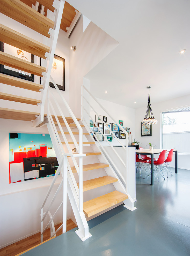 Contemporary wood staircase in Ottawa with open risers.