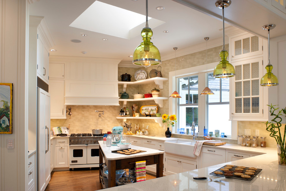 Inspiration for a mid-sized traditional u-shaped eat-in kitchen in Other with shaker cabinets, a farmhouse sink, panelled appliances, white cabinets, terrazzo benchtops, yellow splashback, ceramic splashback, medium hardwood floors and with island.