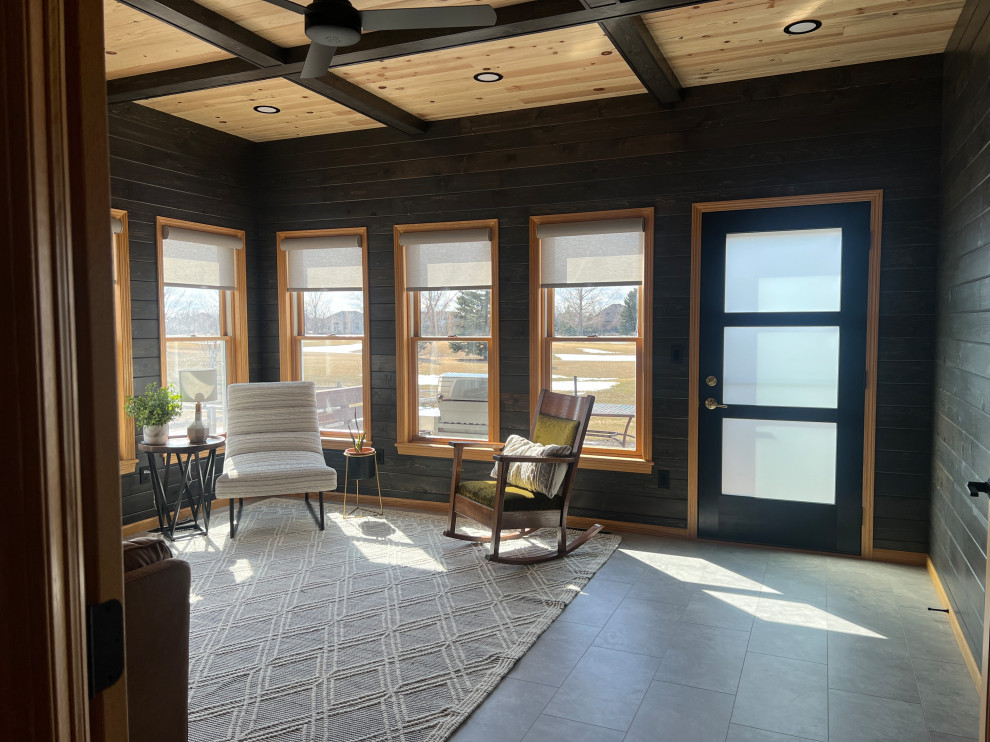 Inspiration for a mid-sized transitional laminate floor and gray floor sunroom remodel in Other