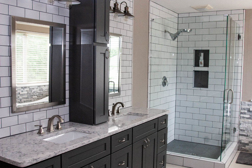 Design ideas for a mid-sized contemporary master bathroom in Cincinnati with recessed-panel cabinets, black cabinets, a corner tub, a corner shower, white tile, ceramic tile, beige walls, marble floors, an undermount sink, beige floor, a hinged shower door and beige benchtops.