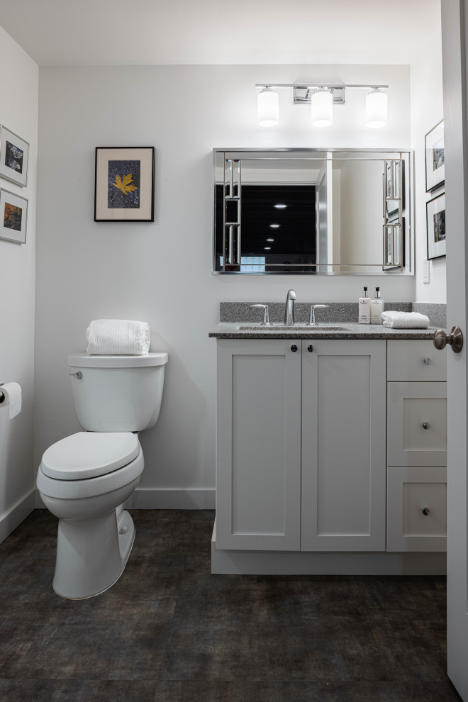 Design ideas for a mid-sized transitional 3/4 bathroom in Detroit with white cabinets, white walls, an undermount sink, a single vanity, a built-in vanity, shaker cabinets, an alcove shower, a two-piece toilet, porcelain floors, engineered quartz benchtops, grey floor, a shower curtain and grey benchtops.
