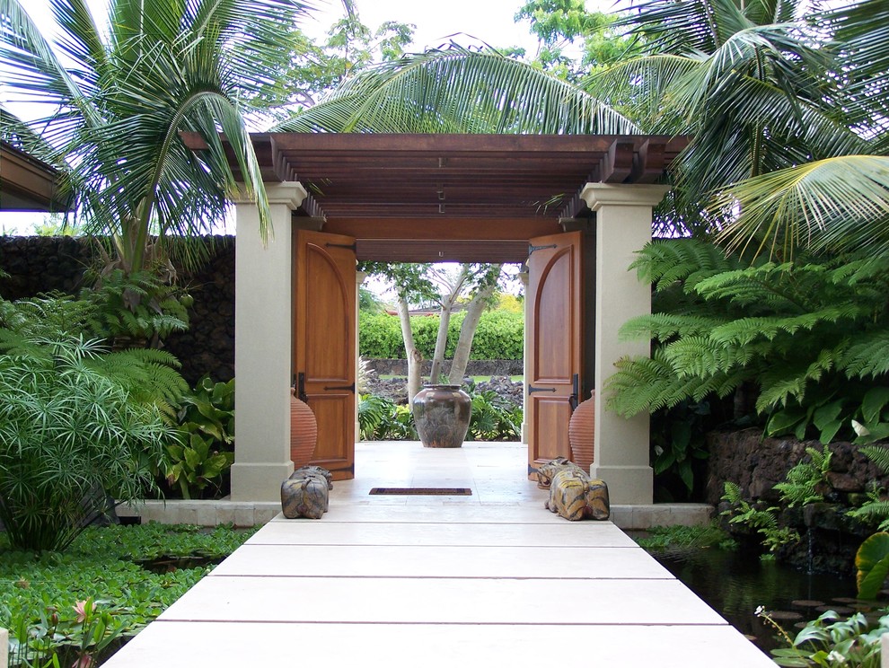 Photo of a mid-sized tropical front yard shaded garden in Hawaii with with pond and concrete pavers.