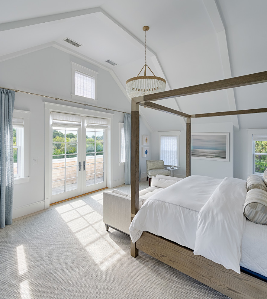 Beach style bedroom in Boston with white walls and grey floor.