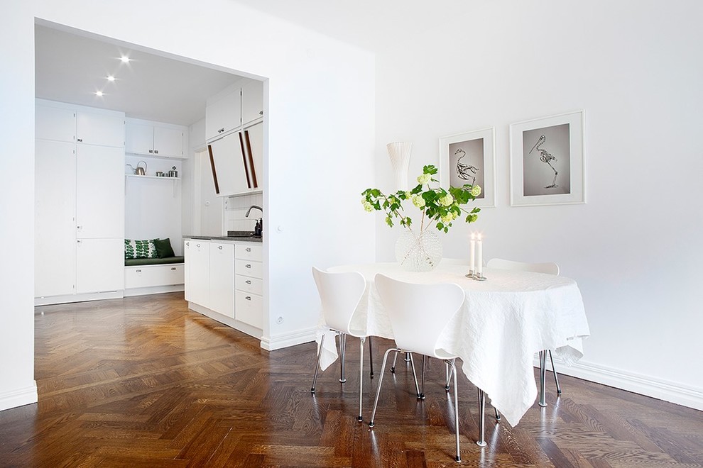 Inspiration for a transitional open plan dining in Stockholm with white walls, dark hardwood floors, no fireplace and brown floor.