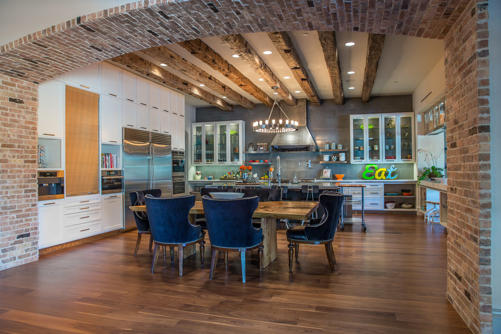 This is an example of a contemporary u-shaped eat-in kitchen in Dallas with glass-front cabinets, white cabinets, grey splashback, stainless steel appliances, medium hardwood floors and with island.