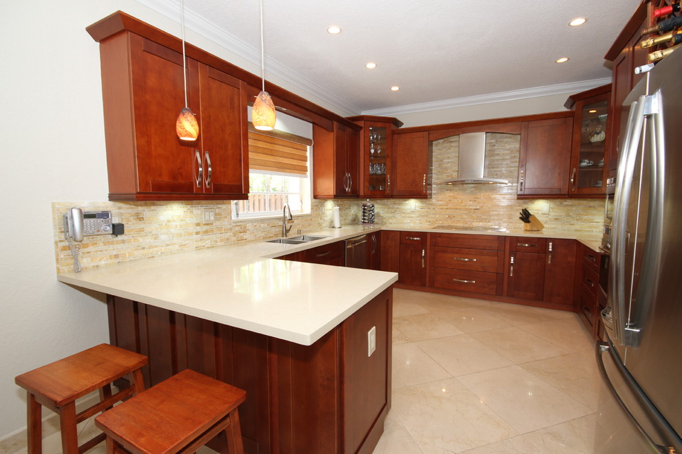 Contemporary u-shaped separate kitchen in Miami with an undermount sink, shaker cabinets, medium wood cabinets, quartzite benchtops, beige splashback and stainless steel appliances.