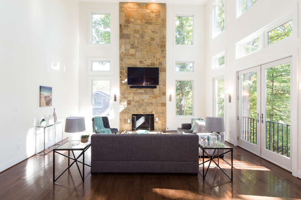 Inspiration for a mid-sized transitional formal open concept living room in DC Metro with white walls, medium hardwood floors, a standard fireplace, a stone fireplace surround, no tv and brown floor.