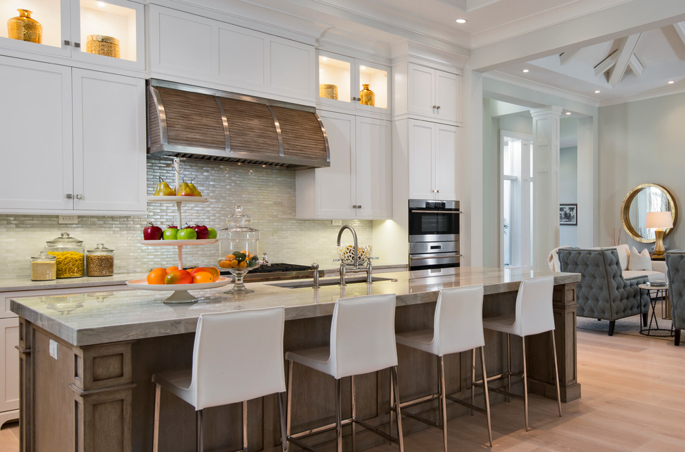 Transitional light wood floor open concept kitchen photo with an undermount sink, shaker cabinets, white cabinets, stainless steel appliances and an island