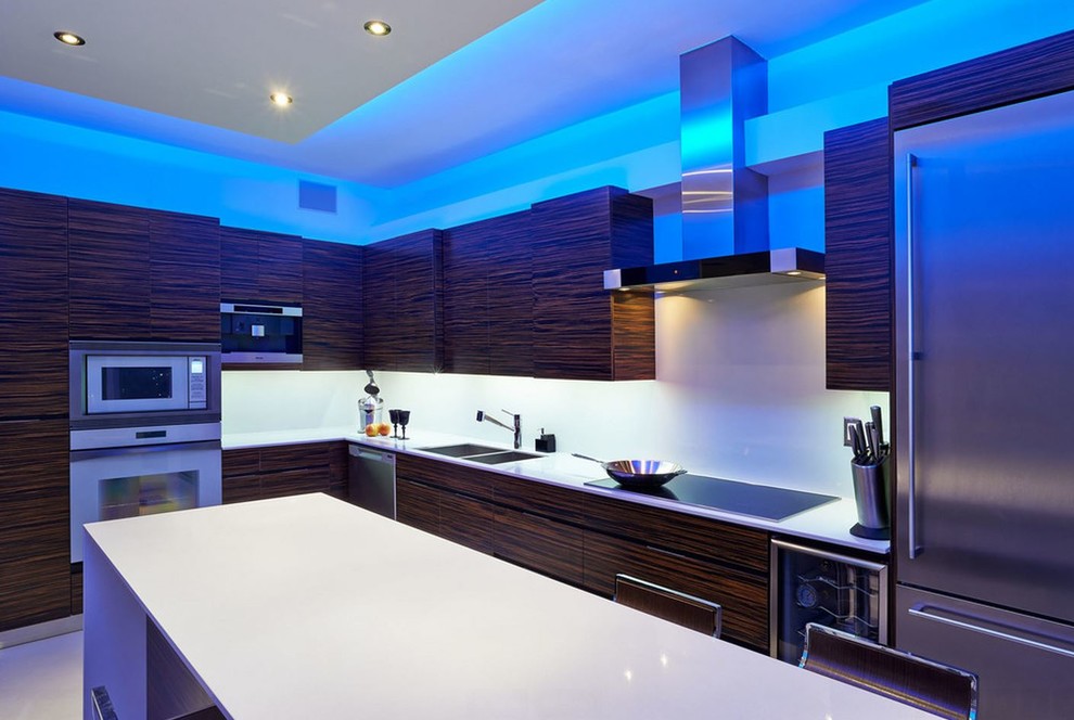 This is an example of a large modern l-shaped separate kitchen in Other with a double-bowl sink, flat-panel cabinets, brown cabinets, quartz benchtops, white splashback, porcelain splashback, stainless steel appliances, porcelain floors, with island and white floor.